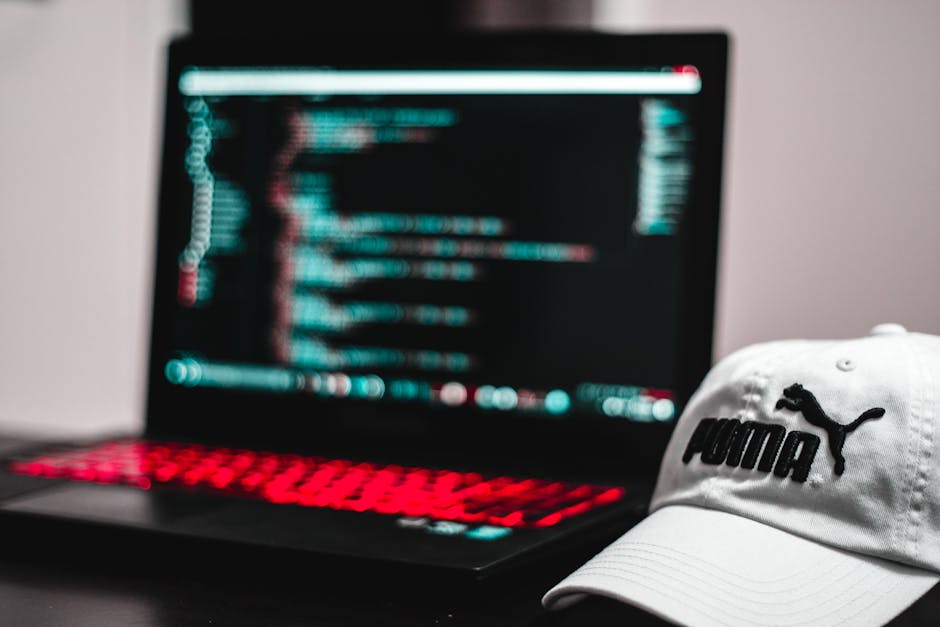 A close-up view of a computer screen displaying a code editor with multiple lines of HTML and CSS code in various colours, including red, green, blue, and purple, on a dark background. The code appear